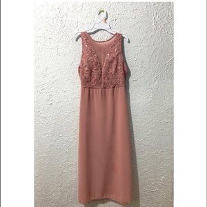 Baby pink dress. Dress has bra pads. Small stains.